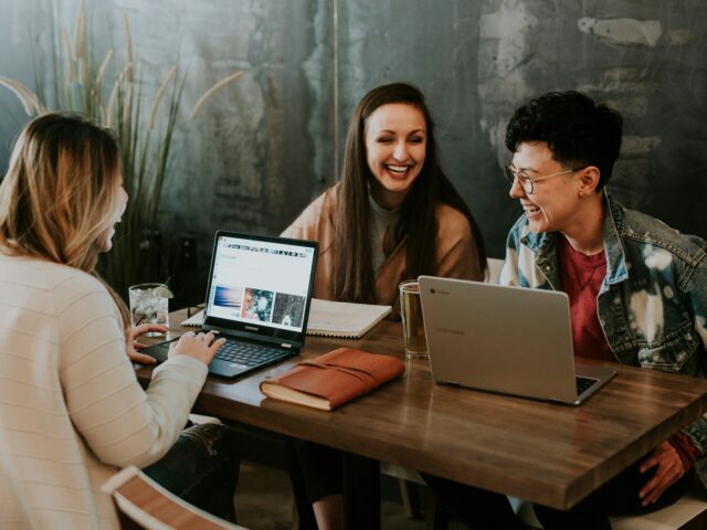 Team arbeitet gemeinsam an Laptops